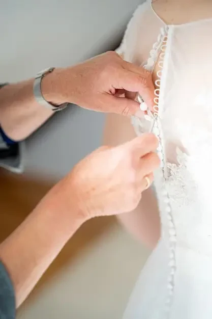C:\Users\hp\Downloads\Close up shot of a person helping zip the beautiful wedding dress