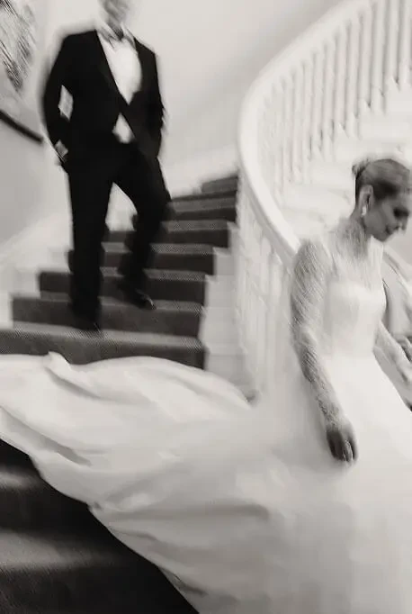 Сouple wearing a white gown and a black suit