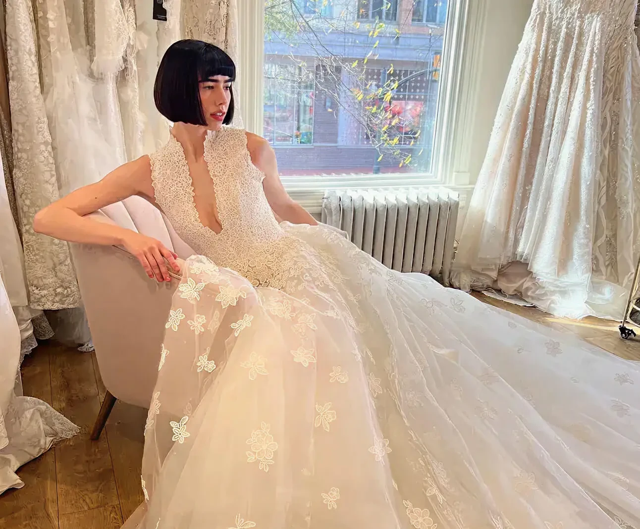 Model wearing a white gown. Mobile image